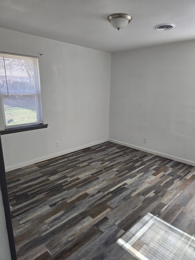 unfurnished room with dark hardwood / wood-style flooring