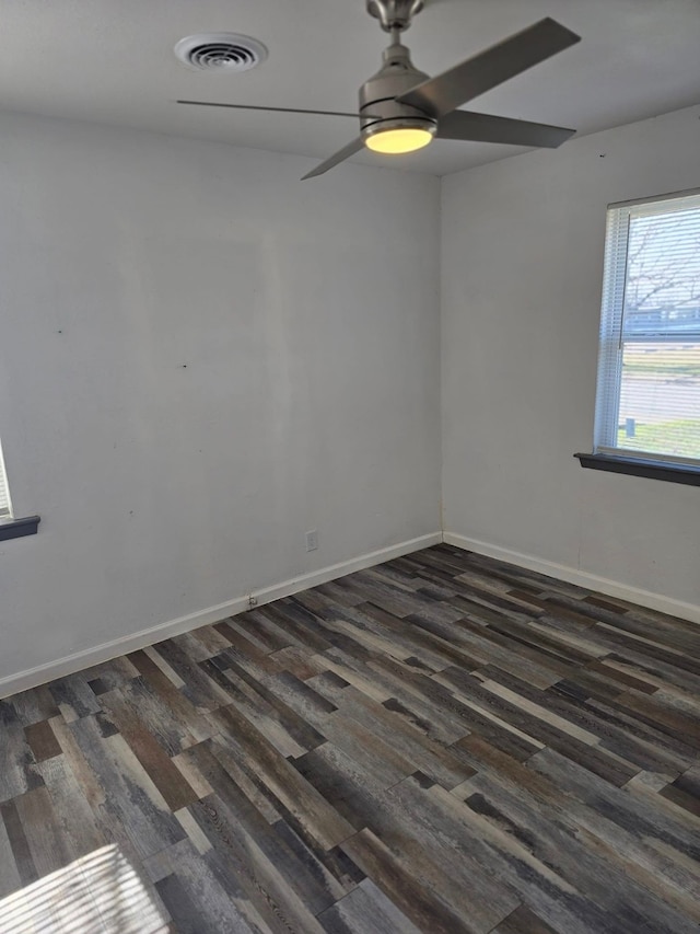 spare room with dark wood-type flooring and ceiling fan