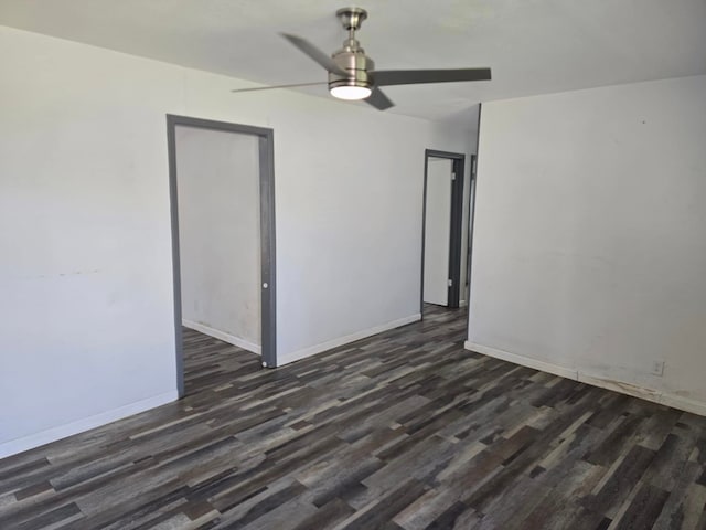 empty room featuring ceiling fan and dark wood-type flooring