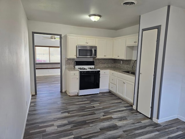 kitchen featuring white cabinetry, white gas range, and sink