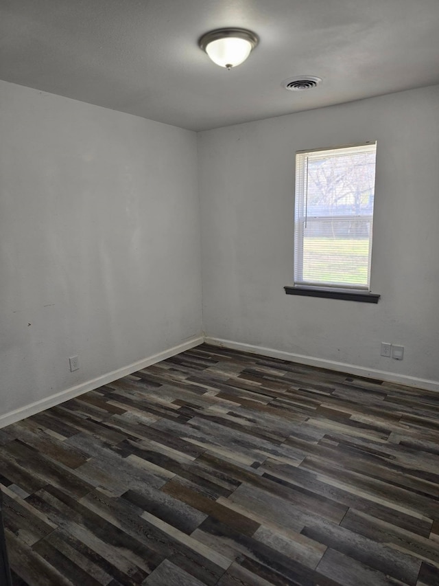 empty room with dark hardwood / wood-style floors