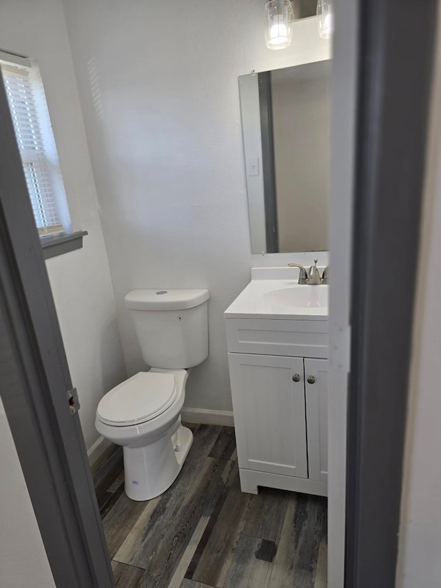 bathroom featuring vanity, hardwood / wood-style floors, and toilet