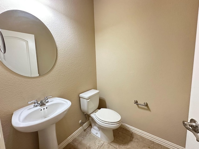 bathroom with tile patterned flooring and toilet