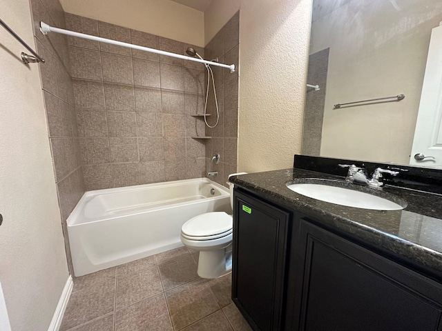 full bathroom featuring tile patterned flooring, tiled shower / bath combo, toilet, and vanity