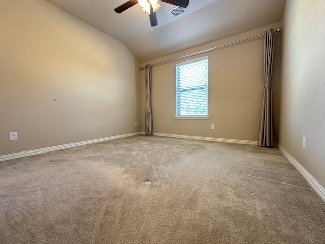 carpeted empty room featuring vaulted ceiling and ceiling fan