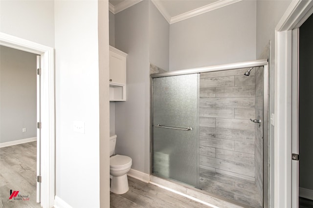 bathroom with ornamental molding, hardwood / wood-style floors, an enclosed shower, and toilet