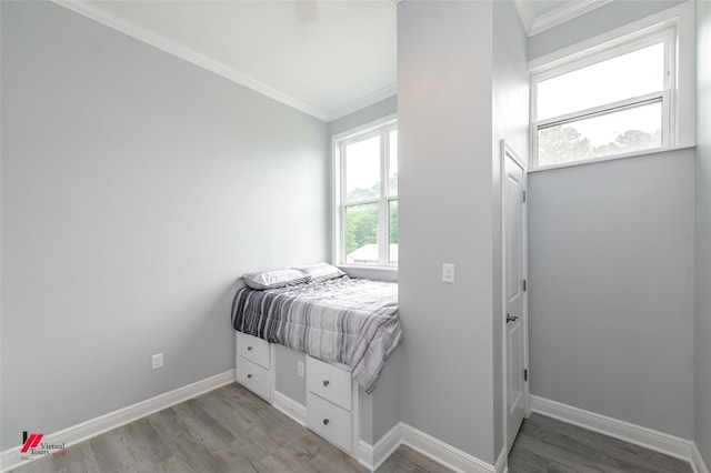 bedroom with ornamental molding, ceiling fan, and light wood-type flooring