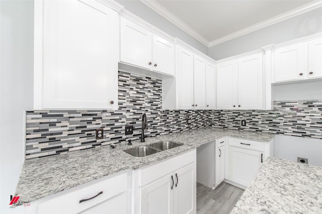 kitchen with white cabinetry and crown molding