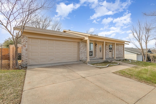 ranch-style house with a garage, a front yard, and covered porch