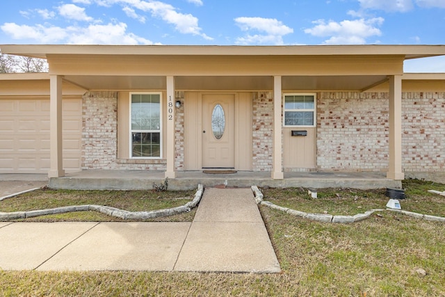 property entrance with a garage and covered porch