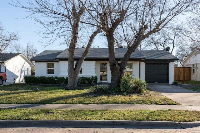 single story home featuring a garage and a front lawn