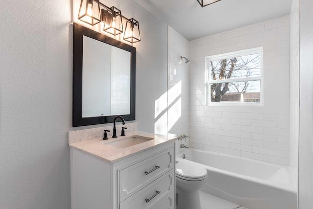 full bathroom with vanity, toilet, and tiled shower / bath