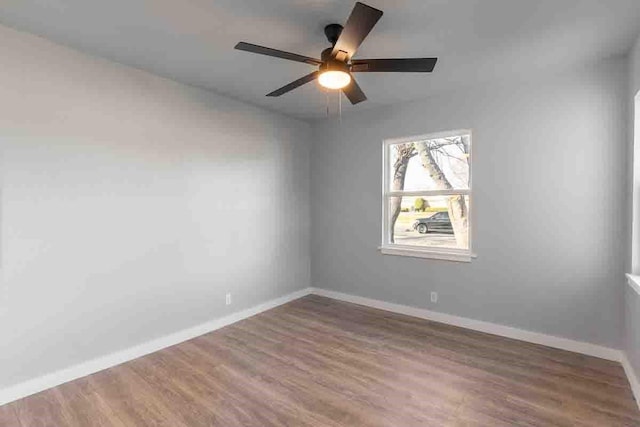 spare room with hardwood / wood-style flooring and ceiling fan