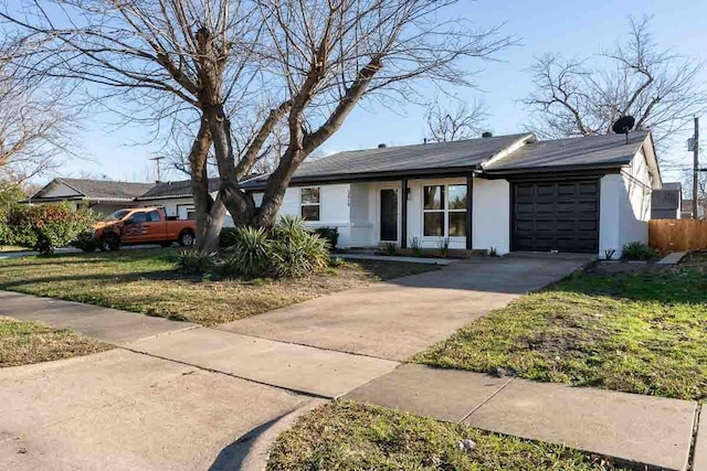 ranch-style home with a garage and a front lawn