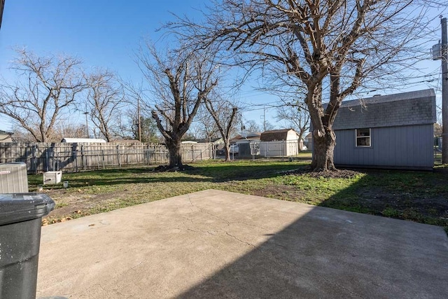 view of yard with central AC, a storage unit, and a patio area