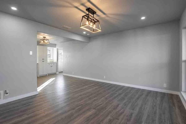 empty room with dark hardwood / wood-style flooring