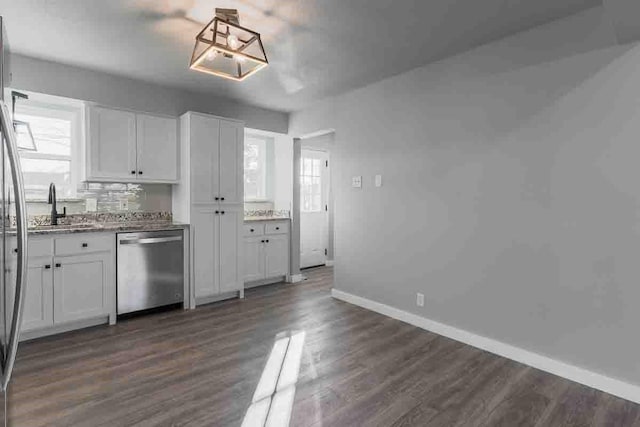 kitchen featuring dishwasher, white cabinets, dark wood-type flooring, and sink