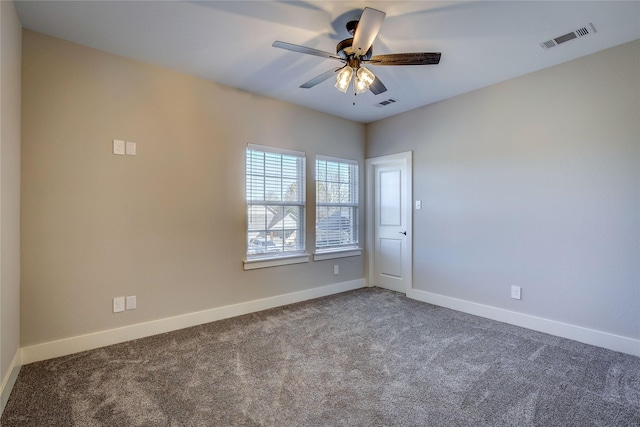 carpeted spare room featuring ceiling fan