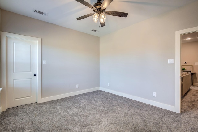 carpeted spare room featuring ceiling fan