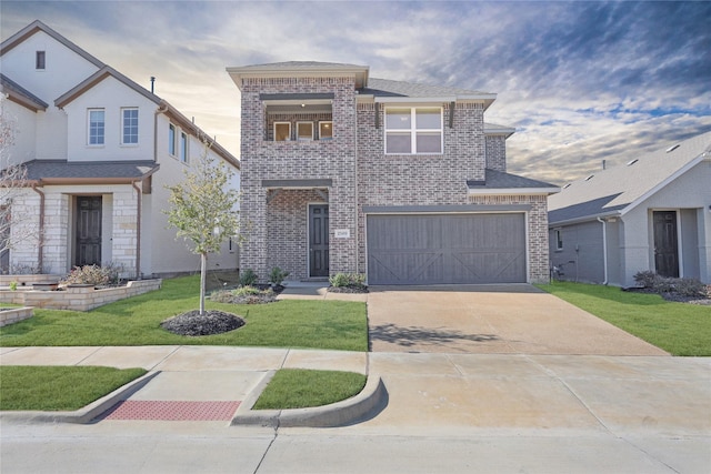 view of front of home featuring a garage and a lawn