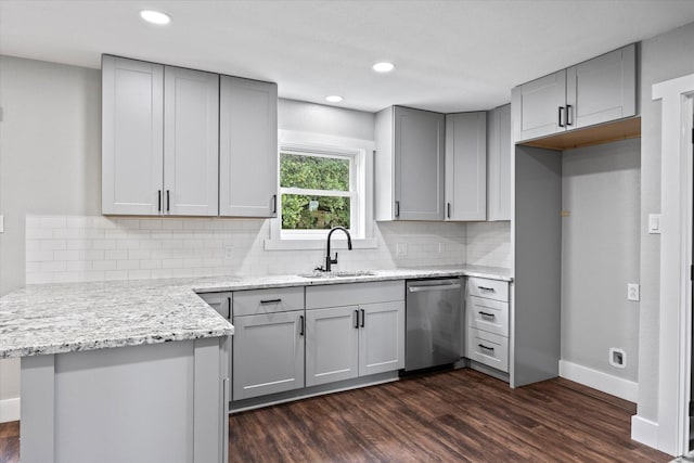 kitchen with dishwasher, sink, dark wood-type flooring, kitchen peninsula, and gray cabinets