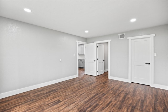 unfurnished bedroom with dark hardwood / wood-style flooring