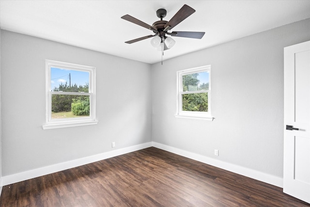 spare room featuring ceiling fan and dark hardwood / wood-style floors