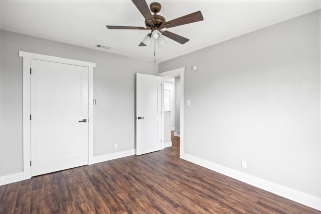 unfurnished bedroom with ceiling fan and dark hardwood / wood-style flooring