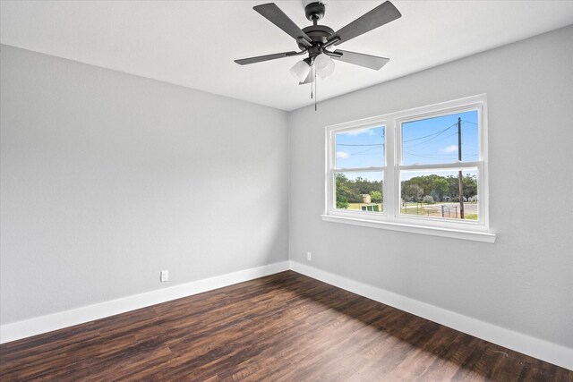 spare room with ceiling fan and dark hardwood / wood-style floors