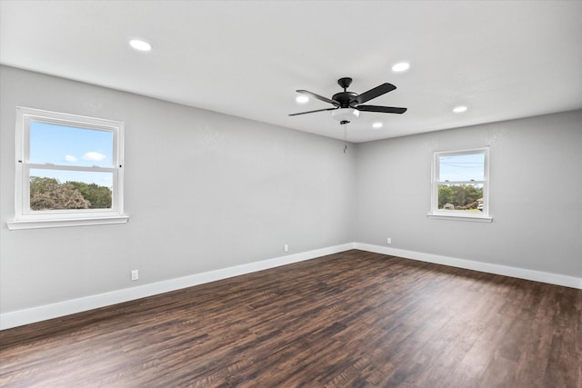 unfurnished room with ceiling fan and dark wood-type flooring