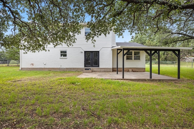 back of house with a yard and a patio area