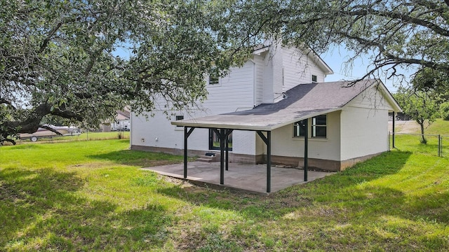 rear view of house with a lawn and a patio area