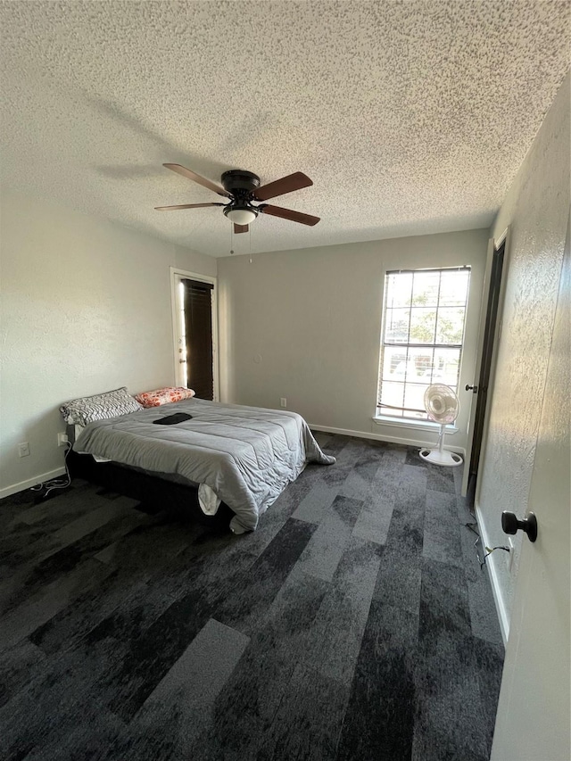 unfurnished bedroom with carpet flooring, ceiling fan, and a textured ceiling