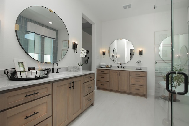 bathroom with vanity and a shower with door