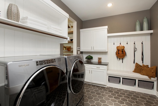 laundry room with independent washer and dryer and cabinets