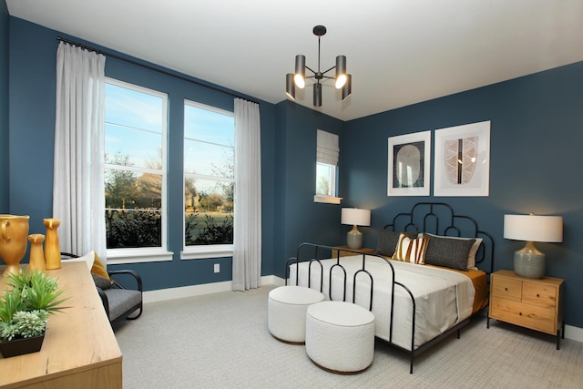 carpeted bedroom with a notable chandelier