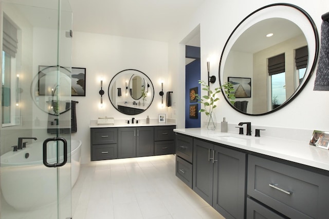 bathroom with vanity and independent shower and bath