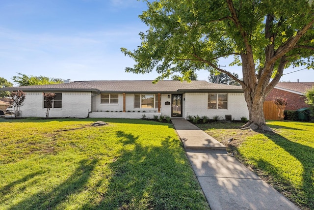 ranch-style home with a front lawn