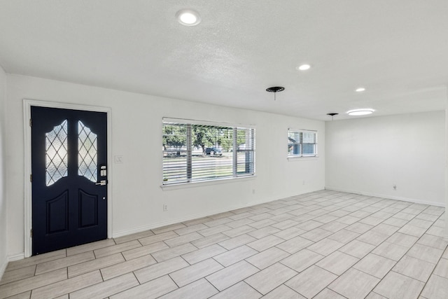 foyer featuring a textured ceiling