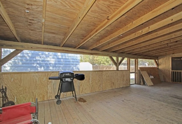 exterior space with hardwood / wood-style floors and wooden walls