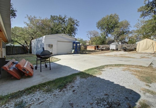 view of yard featuring a storage unit and a garage