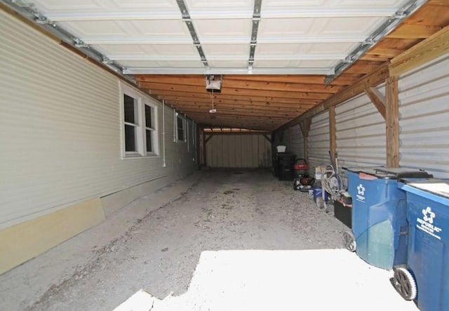 garage featuring a garage door opener and a carport