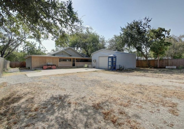 exterior space with a garage and an outdoor structure