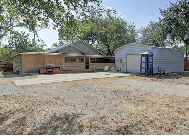 view of front of property with a garage and an outdoor structure