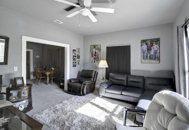 carpeted living room featuring ceiling fan