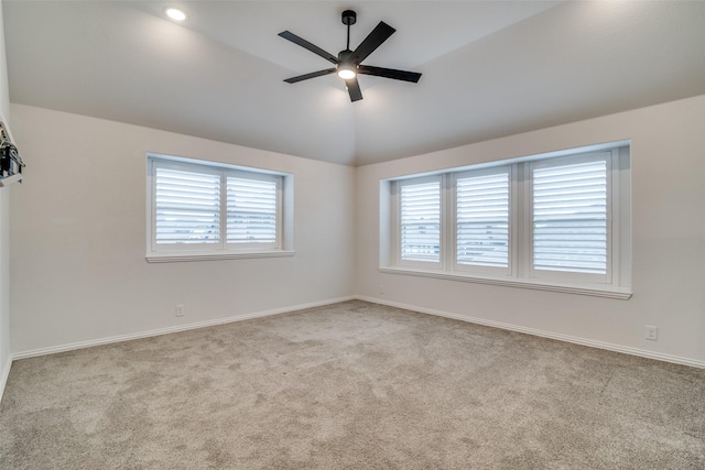 carpeted spare room with lofted ceiling and ceiling fan