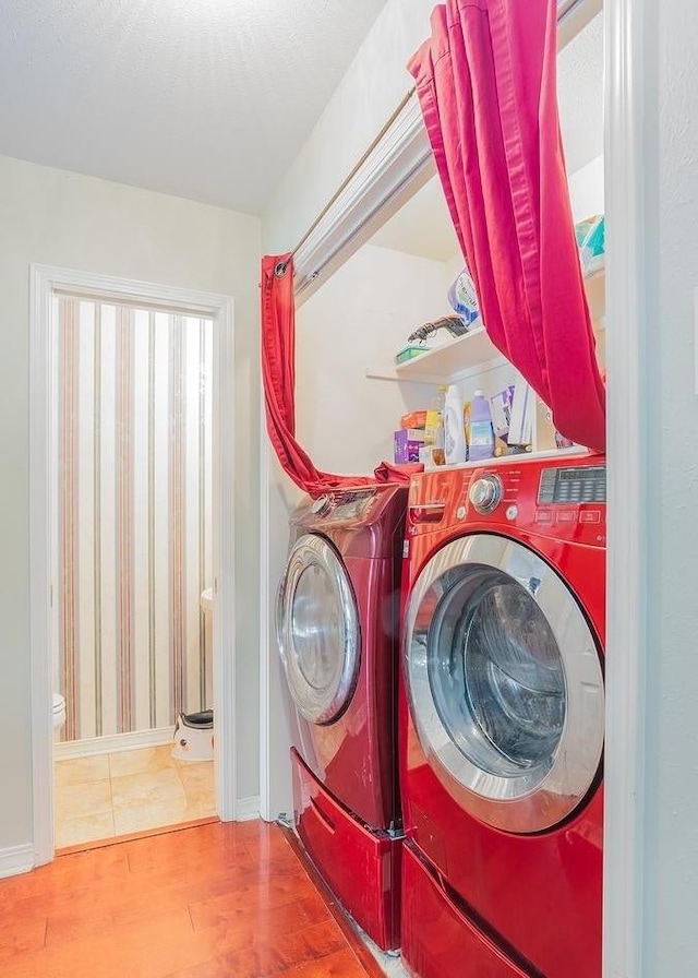 laundry area featuring separate washer and dryer and wood-type flooring