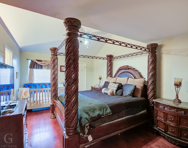 bedroom featuring vaulted ceiling and dark hardwood / wood-style floors