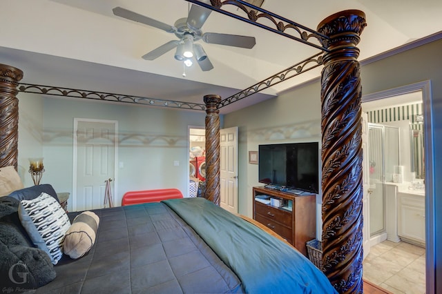 bedroom with light tile patterned floors, connected bathroom, and ceiling fan