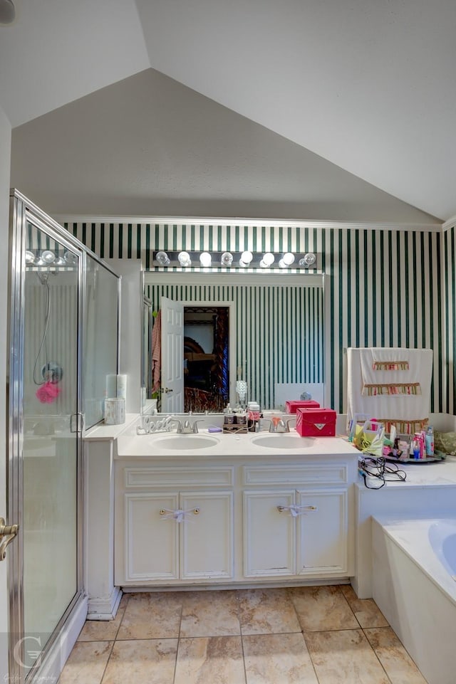 bathroom with tile patterned floors, vanity, independent shower and bath, and vaulted ceiling